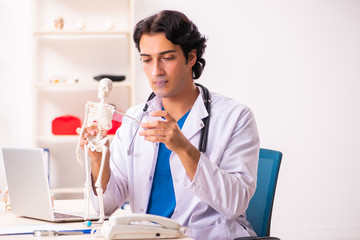 Young male doctor with skeleton 