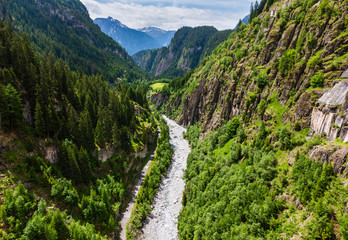 Fototapeta na wymiar Summer Alps mountain landscape with river in deep ravine, Switzerland
