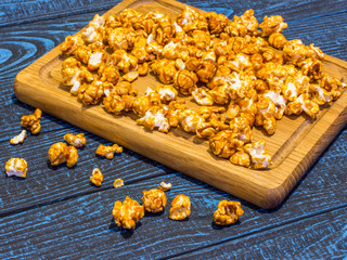 Popcorn with caramel on a blue background