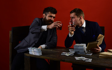 Time to relax. Businessmen write financial report while drinking and smoking. Business partners with cash money. Money brokers counting profit increase. Successful investment in business