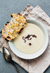 Potato cauliflower soup puree on a gray background, top view. Vegetarian healthy food concept