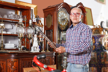 man visiting shop of antique goods