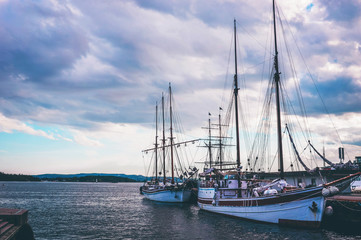 Fototapeta premium Picture of sailboats reflected in water, yacht port on the bay, water transport