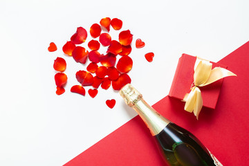 Two glasses with rose petals and a bottle of wine for Valentine's Day