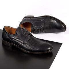 Classic male black leather shoes isolated on a white and black