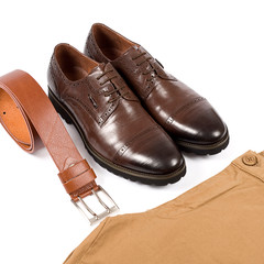 Men's leather shoes and belt on a white background