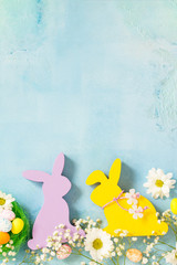 Happy Easter Card. Congratulatory easter background. Easter eggs, Easter eggs cute bunny and flowers. Top view flat lay background. Copy space.
