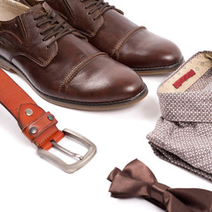 Men's leather brown shoes and belt on a white background