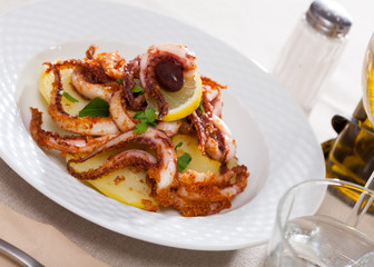 Fried tentacles squid with potatoes