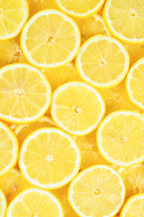 A slices of fresh juicy yellow lemons.  Texture background, pattern.