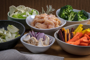 Pieces of raw chicken meat and vegetables ready for cooking