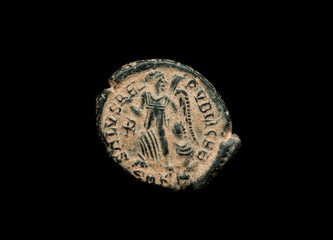Ancient copper or bronze coin isolated on black, closeup