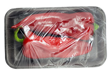 Sweet red pepper in the plastic package isolated on a white background with a clipping path. View from top