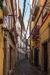 Fototapeta na wymiar Lisbon, Portugal, June 16, 2018: Old narrow streets in Lisbon with different decorations