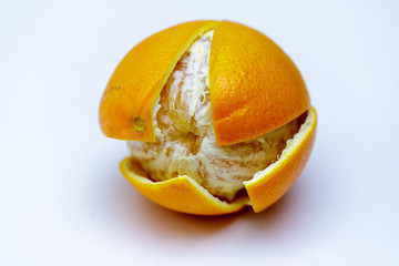 Fototapeta na wymiar Whole orange on white background with cut peel close up.