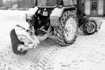 Tractor cleaning snow in a park