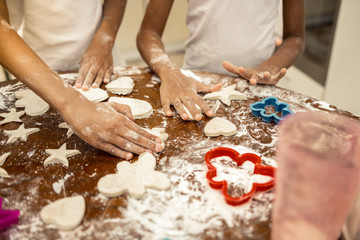 Close up of cute little girls forming Christmas cookies together