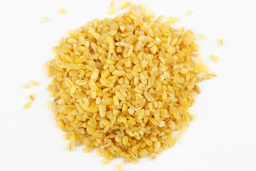 Pile of raw bulgur seeds on a white background
