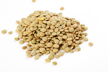 Pile of green lentils on a white background