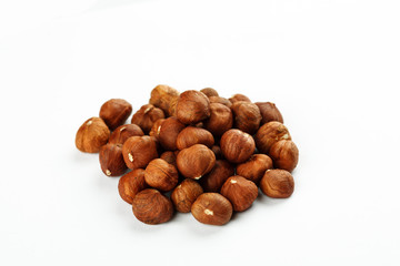 Pile of raw hazelnut on a white background