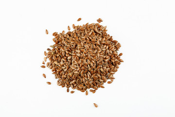 Pile of flax seeds on a white background