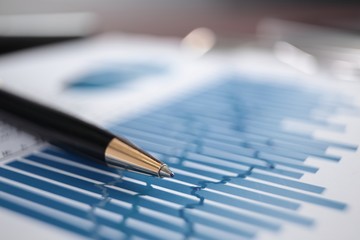 close up. blurred image pen and financial chart