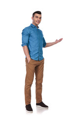 relaxed casual man standing and presenting to side