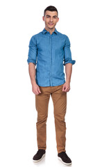 young and handsome man wearing blue shirt standing