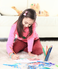 smiling girl paints with pencils. photo with copy space