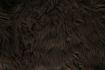 Grey artificial fur background. Fur fabric texture dark background.