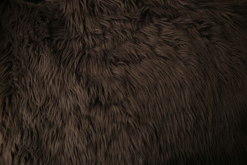 Grey artificial fur background. Fur fabric texture dark background.