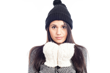 pretty brunette woman with a woolen hat a sweater and gloves that has cold