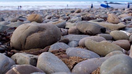 Large stone pebbles on an Atlantic beach looking towards the ocean