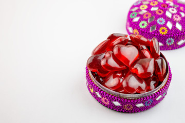 Colorful jewelry box full of red hearts on white bacground - valentine day concept