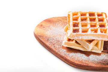 belgian waffles with icing sugar and maple syrup
