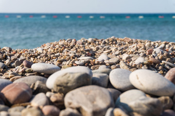 Pebbles on the shore and the sea horizon