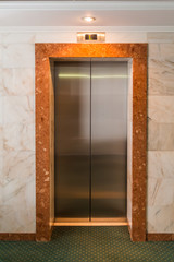 Metal Elevator doors in the lobby. Corridor in a hotel.