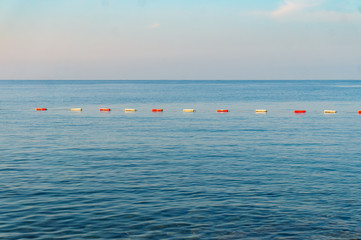 Row of red and white buoys in the sea