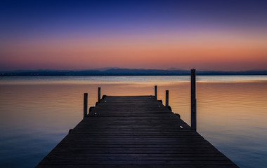 Obraz na płótnie Canvas Pier at sunset on the lake