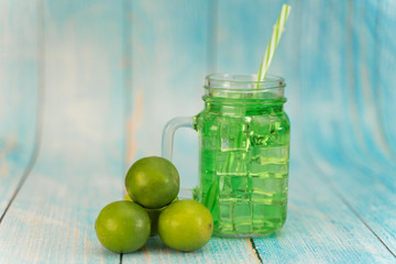 Lemonade summer cold drink with wooden background