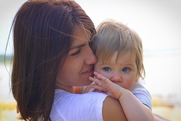 Love and tender hugs of mother and little daughter. Care and motherhood.