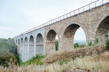 Railroad bridge in mountains. Mountain railroad bridge scene. Railroad bridge and landscape