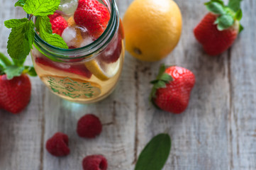 Still life raspberries and strawberries on a wooden table