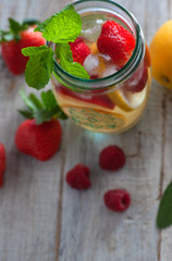 Still life raspberries and strawberries on a wooden table