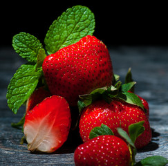 Still life raspberries and strawberries on a wooden table