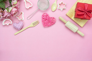 Table top view aerial image of decoration valentine's day background concept.Flat lay essential items love and gift box with cooking items with rose on modern pink paper.blank space for mock up.