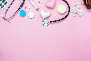 Table top view of accessories healthcare & medical with valentines day background concept.Essential instrument tools with heart shape on pink paper.Flat lay essential items doctor using treat patient.