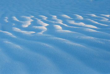 Snow waves at sunset. Wallpaper with sun rise on snow