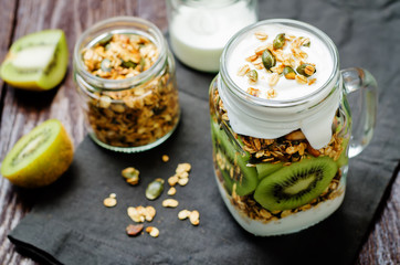Greek yogurt granola kiwi breakfast in jar