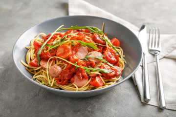 Delicious pasta with sausage and sauce on plate